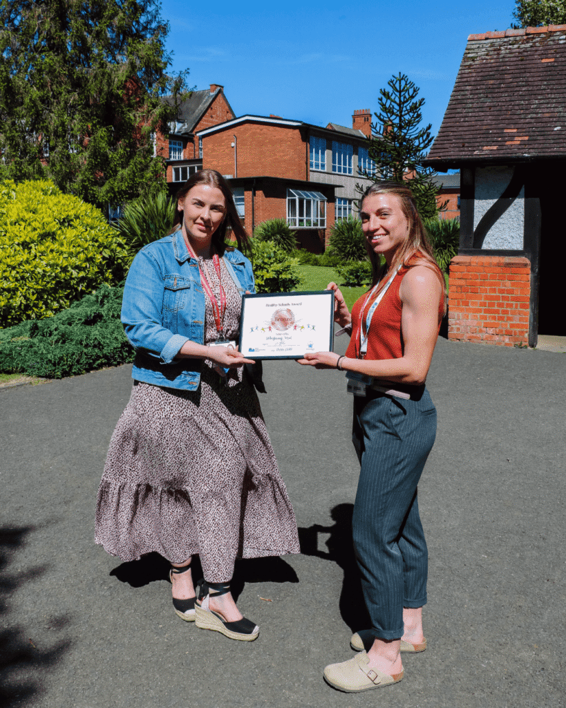 School wellbeing team receiving award at school.